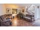 Cozy living room with plush seating, decorative art, piano, and a staircase at 1557 Blue Sierra Ct, Henderson, NV 89074