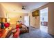 Spacious main bedroom with plush carpeting, ceiling fan, and a view into the main bathroom at 1557 Blue Sierra Ct, Henderson, NV 89074