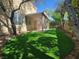 Spacious backyard featuring a covered patio area and lush artificial grass, great for entertaining at 1812 Warrenville St, Las Vegas, NV 89117