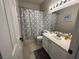 Bright bathroom featuring a shower-tub combination with a decorative shower curtain and vanity at 1812 Warrenville St, Las Vegas, NV 89117