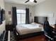 Modern bedroom with a bed, desk, and entertainment area at 1812 Warrenville St, Las Vegas, NV 89117