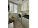 Efficient laundry room with modern washer and dryer, window for natural light, and storage at 1812 Warrenville St, Las Vegas, NV 89117