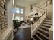 Bright living room featuring high ceilings, a fireplace, hardwood floors, and a staircase at 1812 Warrenville St, Las Vegas, NV 89117