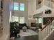 Sun-filled living room with a stone fireplace, high ceilings, hardwood floors, and ample natural light at 1812 Warrenville St, Las Vegas, NV 89117