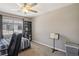 Bedroom with a large window, ceiling fan, modern bookshelf and gray carpeting at 1922 Via Delle Arti, Henderson, NV 89044