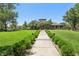 A grand clubhouse view showcases manicured lawn and inviting walkway, perfect for community gatherings at 1922 Via Delle Arti, Henderson, NV 89044