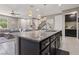 Open kitchen features a large island with granite countertops and stainless steel appliances at 1922 Via Delle Arti, Henderson, NV 89044