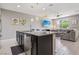 Modern kitchen island with breakfast bar, stainless steel dishwasher, and pendant lighting at 1922 Via Delle Arti, Henderson, NV 89044