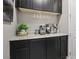 Butler's pantry featuring granite countertops, dark cabinetry and wine glass rack at 1922 Via Delle Arti, Henderson, NV 89044