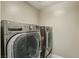 Laundry room with LG front loading washer and dryer, offering convenience and efficiency at 1922 Via Delle Arti, Henderson, NV 89044