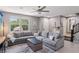 Spacious living room with a large sectional sofa, contemporary decor, and ample natural light at 1922 Via Delle Arti, Henderson, NV 89044