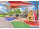 Colorful playground with sunshade featuring a rocking horse and climbing toy for active play at 1922 Via Delle Arti, Henderson, NV 89044