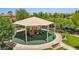 Bright playground with sunshade and rubber ground cover, offering safe fun in community at 1922 Via Delle Arti, Henderson, NV 89044