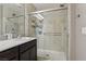 Bathroom with a big shower featuring stone-look tile, showerhead, and built in shelves at 1922 Via Delle Arti, Henderson, NV 89044