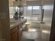 Bathroom featuring a shower, double sinks, tile floors, and natural light at 2050 N Los Feliz St # 170, Las Vegas, NV 89156