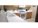 Bright kitchen features a tile countertop, white appliances, and wood cabinets at 2050 N Los Feliz St # 170, Las Vegas, NV 89156