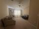 Living room area with ceiling fan and neutral carpet at 2050 N Los Feliz St # 170, Las Vegas, NV 89156