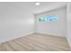 Bright bedroom with wood-look flooring and window with exterior view at 2105 Berkley Ave, Las Vegas, NV 89101