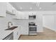 Modern kitchen featuring white cabinets, stainless steel appliances and wood-look flooring at 2105 Berkley Ave, Las Vegas, NV 89101