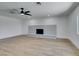 Bright living room with fireplace, ceiling fan, and wood floors at 212 View Dr, Las Vegas, NV 89107