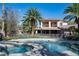 A backyard with a pool, hot tub, palm trees, and a view of the home at 2285 Villefort Ct, Las Vegas, NV 89117