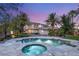 Beautiful backyard featuring a sparkling pool, relaxing spa, and well-manicured tropical landscaping for an inviting outdoor space at 2285 Villefort Ct, Las Vegas, NV 89117