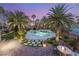 Inviting backyard area with a dazzling pool, spa, lush landscaping, and comfortable seating for outdoor relaxation at 2285 Villefort Ct, Las Vegas, NV 89117