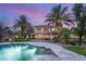Stunning backyard with a spacious pool and spa, lush landscaping, and a covered patio for outdoor entertaining at 2285 Villefort Ct, Las Vegas, NV 89117