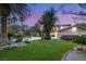 Lush backyard with a sparkling pool, mature trees, and manicured lawn; an entertainer's dream at 2285 Villefort Ct, Las Vegas, NV 89117