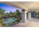 This expansive balcony offers stunning views of the pool, landscape, and tropical palm trees at 2285 Villefort Ct, Las Vegas, NV 89117
