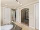 Bathroom featuring a walk in shower with glass door, double sinks, granite countertops, and tile floors at 2285 Villefort Ct, Las Vegas, NV 89117