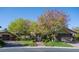 A stunning single-Gathering house boasts mature trees, a stone facade and a well-manicured lawn at 2285 Villefort Ct, Las Vegas, NV 89117