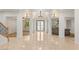 An elegant foyer with a chandelier, marble floors, and bright, open spaces at 2285 Villefort Ct, Las Vegas, NV 89117