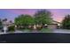 Attractive home showcasing a well-maintained lawn, mature trees, stone accents, and a paved driveway at 2285 Villefort Ct, Las Vegas, NV 89117