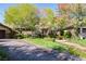 Beautiful home featuring a stone facade, manicured lawn, and a welcoming circular driveway at 2285 Villefort Ct, Las Vegas, NV 89117