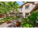 A charming front exterior featuring a stone facade, manicured landscaping, and a brick walkway at 2285 Villefort Ct, Las Vegas, NV 89117