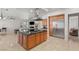 Spacious kitchen featuring a large island with cooktop, stainless steel appliances, and access to the living room at 2285 Villefort Ct, Las Vegas, NV 89117