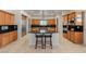 Gourmet kitchen featuring granite countertops, custom cabinetry, and a center island with bar seating at 2285 Villefort Ct, Las Vegas, NV 89117