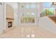 Bright living room featuring a stone fireplace, high ceilings, and an abundance of natural light from large windows at 2285 Villefort Ct, Las Vegas, NV 89117