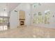 An open living room with a fireplace, tall windows, and bright lighting at 2285 Villefort Ct, Las Vegas, NV 89117