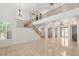 Open living room features tile flooring, high ceilings, and a staircase leading to a second floor landing at 2285 Villefort Ct, Las Vegas, NV 89117