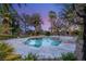 Inviting pool and spa surrounded by lush landscaping and palm trees, perfect for outdoor relaxation at 2285 Villefort Ct, Las Vegas, NV 89117