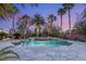 Sparkling pool and spa with stone surround and lush landscaping, creating a private oasis at 2285 Villefort Ct, Las Vegas, NV 89117