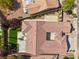 Expansive red tiled-roof house with lush green lawn and manicured landscaping in a well-maintained neighborhood at 2297 Aria Dr, Henderson, NV 89052