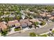 Aerial view of a charming neighborhood showcasing well-maintained homes and tree-lined streets at 2297 Aria Dr, Henderson, NV 89052