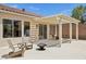 Backyard featuring a covered patio with outdoor seating and a cozy fire pit, perfect for entertaining at 2297 Aria Dr, Henderson, NV 89052