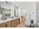 Bright bathroom features a double vanity, large mirrors, and modern fixtures at 2297 Aria Dr, Henderson, NV 89052
