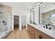 Bright bathroom features a double sink vanity and walk-in shower with glass door at 2297 Aria Dr, Henderson, NV 89052