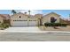 Attractive home featuring a three-car garage and desert landscaping at 2297 Aria Dr, Henderson, NV 89052