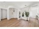 Inviting foyer with an arched entry, decorative lighting, and wood-look floors at 2297 Aria Dr, Henderson, NV 89052